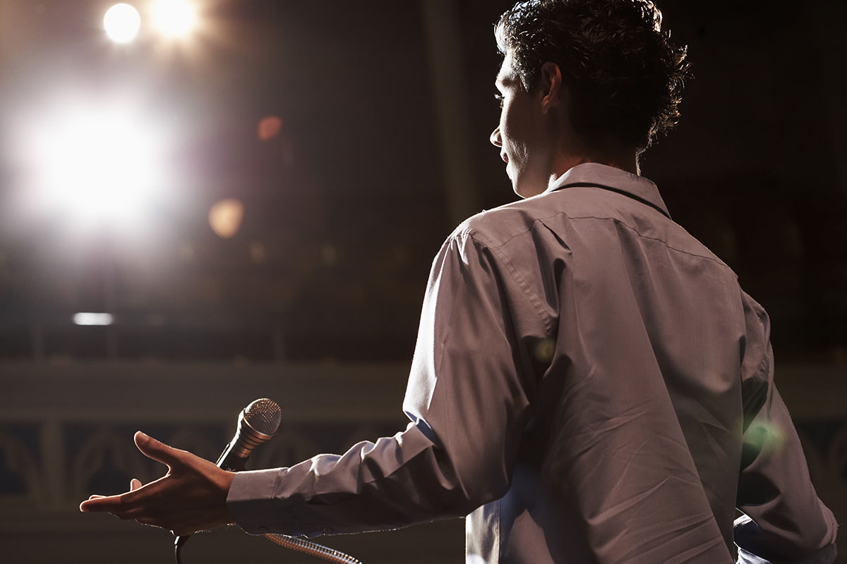 Teen boy standing in front a of microphone